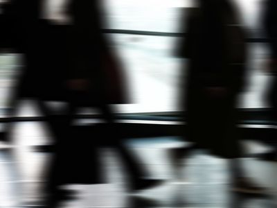 Blurred silhouette of a person exercising in a studio