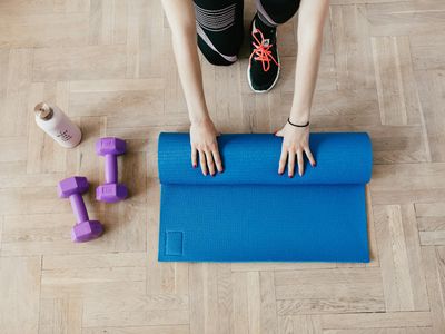 Close up of a yoga mat and water bottle on floor